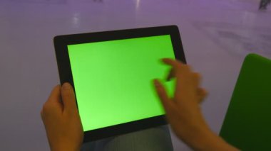 Yeşil ekran alışveriş merkezi ile tablet pc kullanarak eller. İnsanlar paten kapalı buz pateni pisti, arka plan üzerinde çok