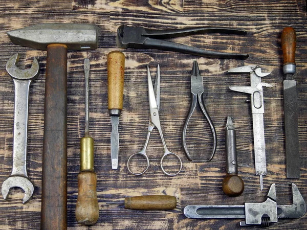 Vintage tools displayed on a background of brown barnboard. — Stock Photo, Image