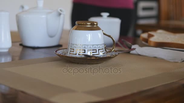 Female hands serving traditional breakfast meal - fried eggs and toast. Putting porcelain plate with eat on wooden table. Close up — Stock Video