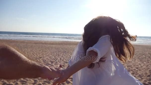 Follow me shot of young woman pull her boyfriend on the sea shore. Girl holding male hand and running on tropical exotic beach to the ocean. Summer vacation or holiday. Point of view. POV Slow motion — Stock Video