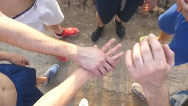 Many male hands getting together. Team of athletes putting arms together outdoor. Group of people joining hands together outside. Friends forming arms stack at nature. Teamwork Close up Top view — Stock Video