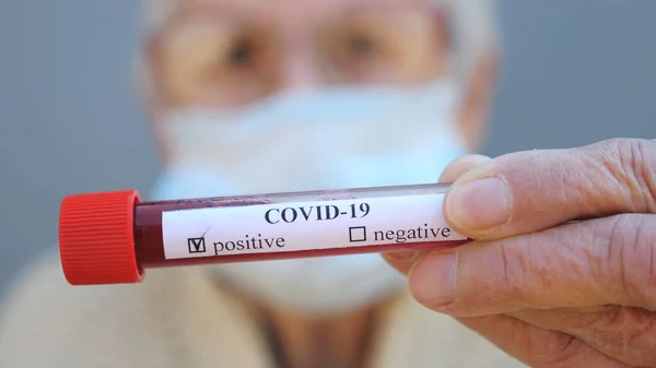 Elderly Woman Protective Mask Holding Her Blood Test Positive Result — Stock Photo, Image