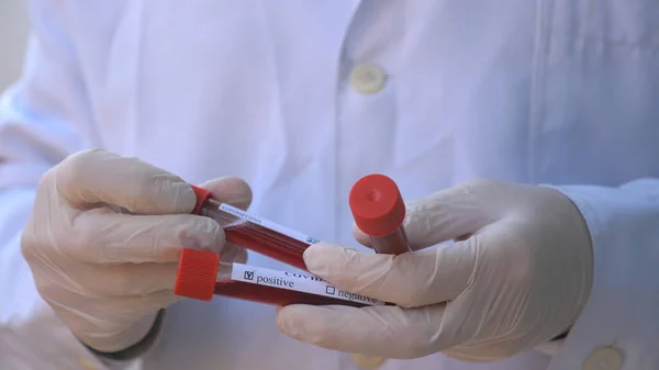 医生或实验室工作人员手里拿着带血样的验尸管 检测Covid 19病毒患者血液样本的医学臂 流行病对健康和安全生命的影响概念 — 图库照片