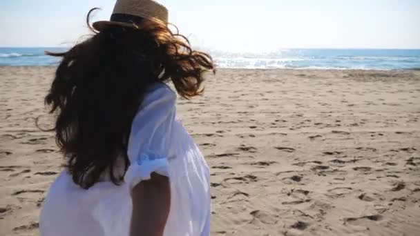 Girl holding male hand and running on tropical beach towards ocean. Follow me shot of woman leading her boyfriend on sea shore. Summer vacation concept. Scenic seascape at background. POV Slow mo — Stockvideo