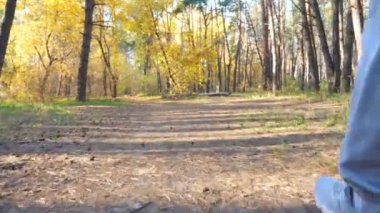 Güneşli bir günde orman yolunda hızla koşan tanınmayan bir adam. Güçlü ve dayanıklı sporcu doğada çalışıyor. Manzaralı odunla kardiyo antrenmanı yapan sporcu adam. Etkin yaşam biçimi kavramı