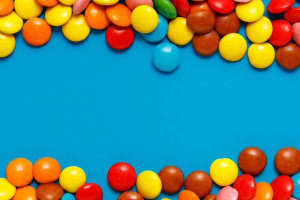 sweet colored candy close up on blue back ground with copy space for text