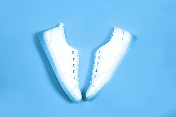 Fashion white sneakers on pastel classic blue background. — Stock Photo, Image