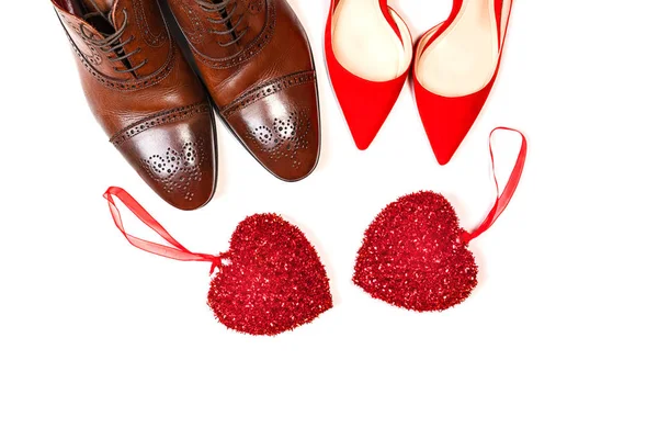 Valentines day concept with man and woman shoes with two red hearts on white background, isolated. — Stok Foto