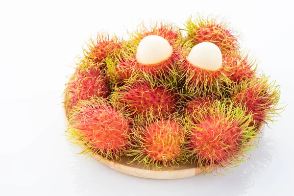 rambutan in the wooden disk on white background