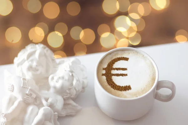 cup of coffee cappuccino with a picture of a Euro sign from cinnamon on milk foam