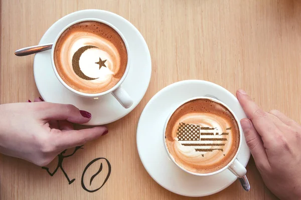 Flag of the United States of America in the form of territorial borders on a cappuccino coffee cup close-up