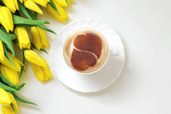 a cup of cappuccino coffee in a ceramic cup on the table