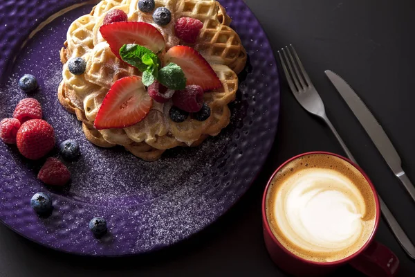 delicious waffles with berries and coffee cup