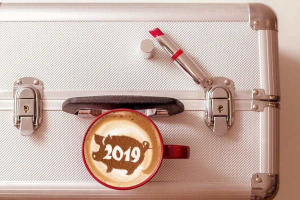 coffee cappuccino in a cup with a pattern of the symbol of 2019 pig on milk foam. The pig is a symbol of the year 2019 in the Chinese calendar.