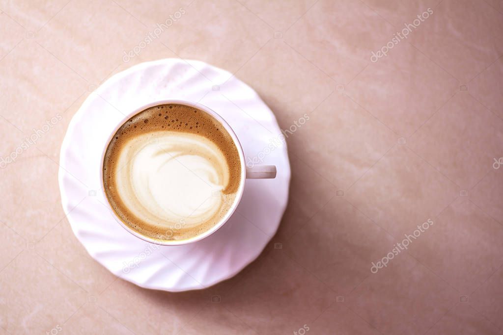 Top view of hot coffee cappuccino latte art in a ceramic glass