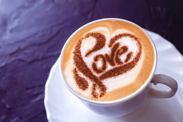 a cup of cappuccino coffee in a ceramic cup on the table