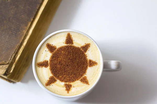 hot cappuccino coffee with sun symbol latte art in white cup