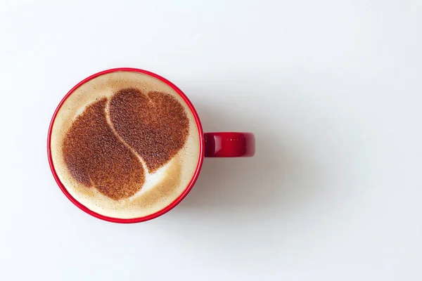 a cup of cappuccino coffee in a ceramic cup on the table