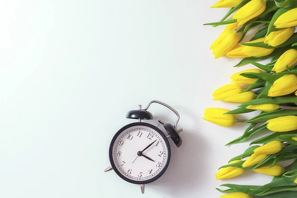黄色チューリップ花束とヴィンテージ目覚まし時計 — ストック写真