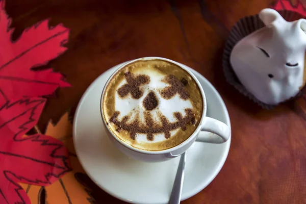 cup of cappuccino coffee with halloween symbol latte art on milk foam