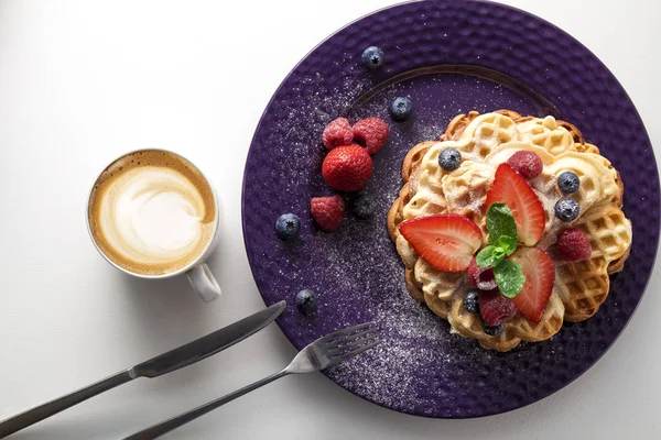 delicious waffles with berries and coffee cup