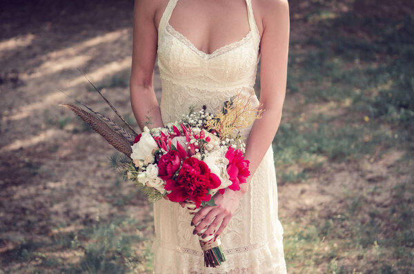 Bride with wedding bouquet in her hands