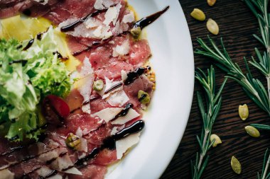 Beyaz bir tabak içinde Dana carpaccio