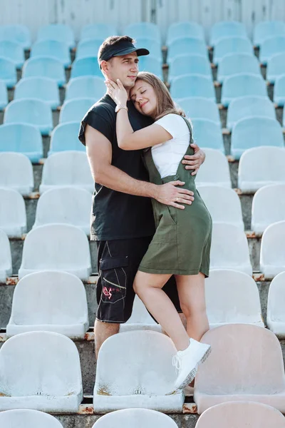 Молодая пара обнимается на стадионе — стоковое фото