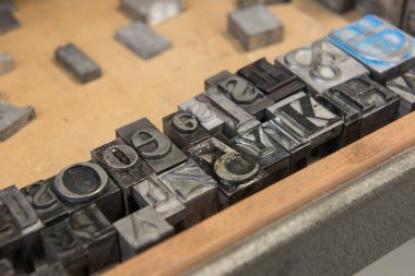 Bokeh ile yıpranmış ahşap çekmece arka plan karşı Vintage kurşun letterpress baskı blokları.