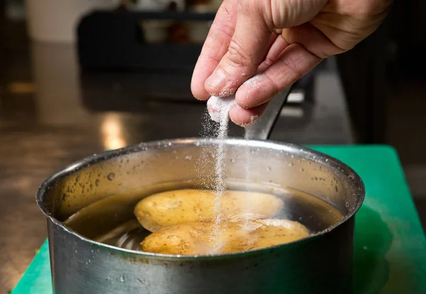 Salt Being Dropped Pan Hot Water Containing Potatoes — Stock Photo, Image