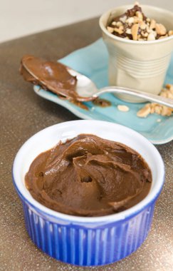 Kremalı çikolatalı mus tatlısı, ezilmiş fındık parçaları ile servis edilir.