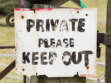 Old creepy private keep out sign on a wooden post. clipart