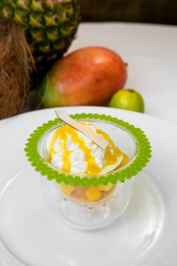 Limonlu, mango ve ananas brunoise çırpılmış krema ve Hindistan cevizi. Ferahlatıcı bir tropikal zesty yaz çöl.