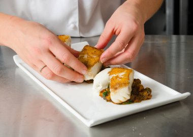 Taze pan katılaşmış, gevrek altın cod curried karnabahar, ıspanak ve patates üzerinde servis fileto, balık. Bir güzel deniz ürünleri yemek.