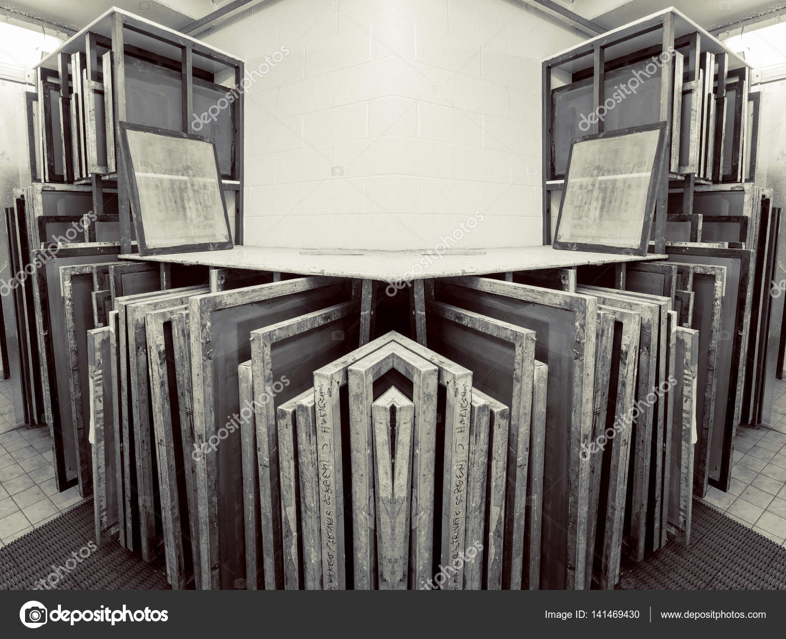 Silk screen printing screens stored in a wooden rack ready for printing.  Stock Photo