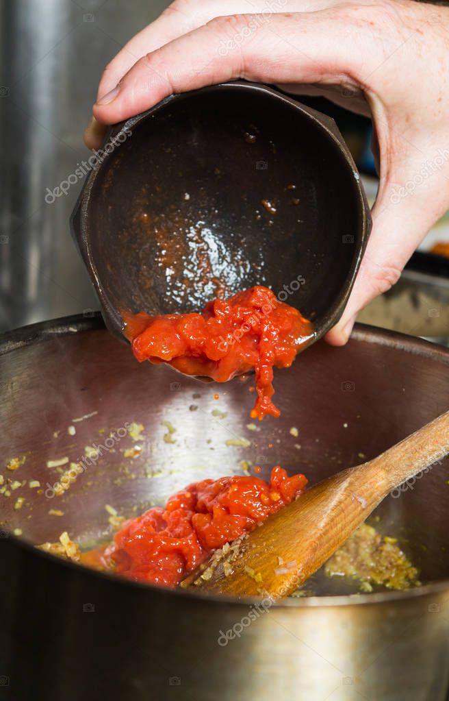 Freshly Chopped Organic Vine Ripened Tomatoes Being Dropped Into A Hot Frying Pan As Part Of A Recipe Stage 148388923 Larastock<script async src=