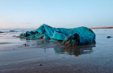 Plastik ambalaj ve çöp kum ve çakıl taşlı plajda kıyıya vurmuş. Çevresel plastik kirliliği sorunu dünya haberlerine neden oluyor. Dünyanın dört bir yanındaki kıyılarda sağlık felaketi.                              