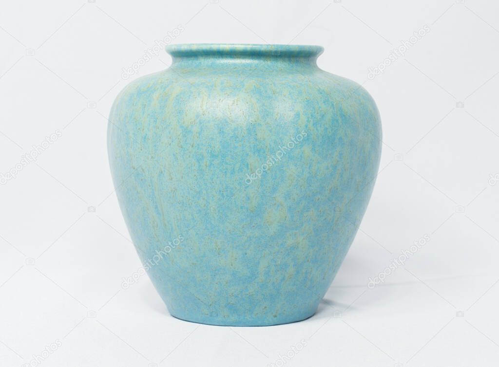 A vintage antique ceramic fragile pottery royal lancastrian 1916 blue and aqua vase isolated on a white background. old pottery pots from the past, found in junk shops and thrift stores. 