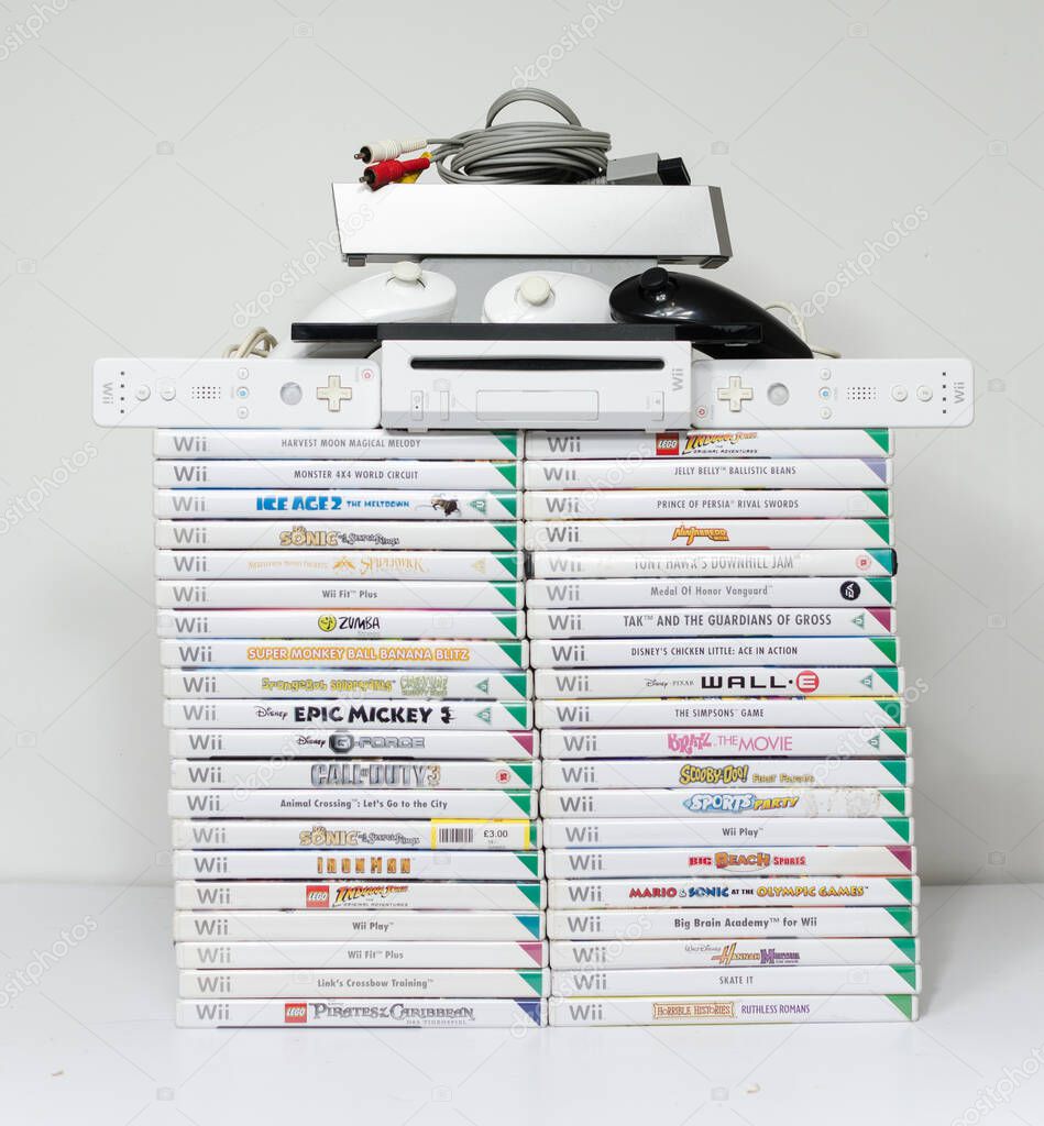 London, england 05/052019 Nintendo wii Console and games on a white isolated background. iconic retro vintage video gaming machine. Japanese technology family gaming fun.