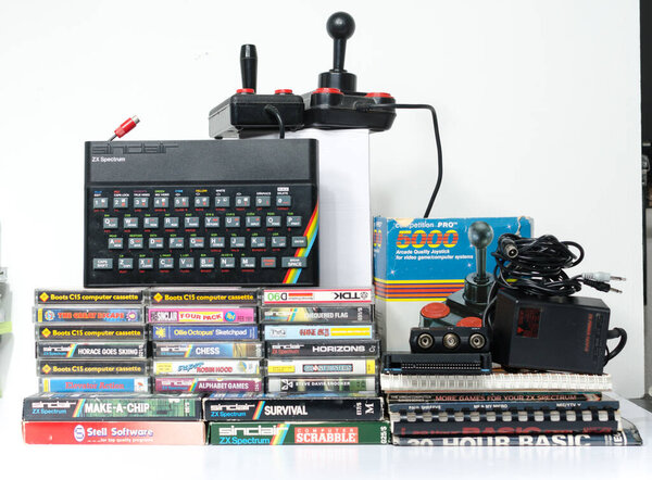 London, eng; and, 05 / 05 / 2019 A retro vintage nostalgic sinclair zx spectrum 48k 80k computer console with games and retro joystick controllers on a white background
. 