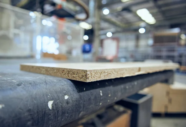 chipboard on an industrial roller conveyor belt in a fully automated factory. roller conveyor to easily move heavy industrial goods around without the need for humans.future of industrial manufacture.