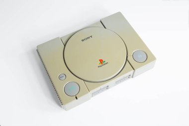 Londra, İngiltere, 07 / 05 / 2018 1994 'ten orijinal Sony Playstation konsolu. PS1 retro video oyun konsolu. Eski ve rengi değişmiş eski bir konsol. Sonys oyun donanım birimi beyaz arkaplanda izole.