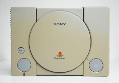 Londra, İngiltere, 07 / 05 / 2018 1994 'ten orijinal Sony Playstation konsolu. PS1 retro video oyun konsolu. Eski ve rengi değişmiş eski bir konsol. Sonys oyun donanım birimi beyaz arkaplanda izole.