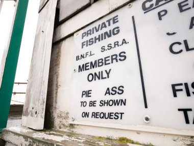 Blackpool, İngiltere, 05 / 05 / 2018 Eski bir balıkçı mensubu sadece levhayı kırdı. Eski bir Viktorya rıhtımında çürüyen deniz kenarı işaretleri. İç karartıcı. kayıp harflerle balıkçı işareti.