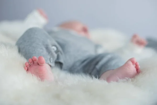 A beautiful soft delicate warm young baby foot photographed with a shallow depth of field. gentle calm colours and feel. baby care and well being. babies feet.