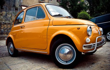 Küçük sarı araba. İtalya'da otopark. Fiat 500 kişilik araba