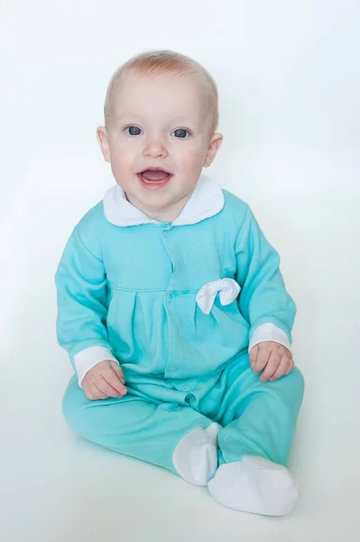 Cute funny little baby girl in turquoise rompers isolated on white background. — Stock Photo, Image