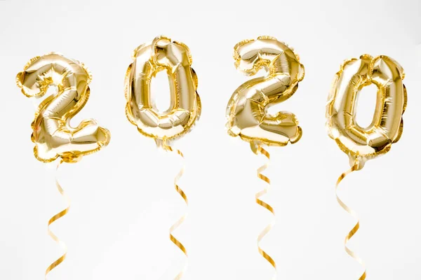 Feliz Año Nuevo 2020 celebración. Números globos de lámina dorada 2020 colgando en el aire sobre fondo blanco —  Fotos de Stock