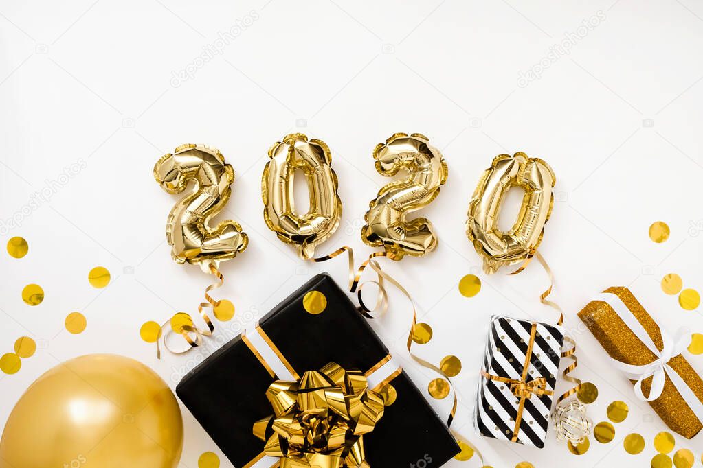 Happy New year 2020 celebration. Gold foil balloons numeral 2020 on white background with gifts