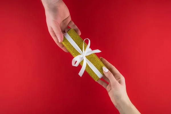 Золотая подарочная коробка с белой лентой на красном фоне ко Дню святого Валентина. Пространство для текста. Открытка, веб-баннер . — стоковое фото